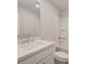 This bright bathroom features a vanity, a large mirror, and a shower-tub combo with built in shelves at 179 Bluffington Way, Marietta, GA 30066