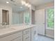 This bright bathroom features a double vanity and a large mirror with views to the backyard at 179 Bluffington Way, Marietta, GA 30066