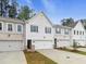 Beautiful townhome with attached garage, manicured lawn, and charming curb appeal at 179 Bluffington Way, Marietta, GA 30066