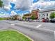 Street view of downtown featuring multiple brick buildings, parked cars, and lush trees under a partly cloudy sky at 179 Bluffington Way, Marietta, GA 30066