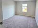 Bright bedroom featuring neutral carpet, a window, and fresh, neutral paint at 2694 Mourning Dove Drive (Lot 35), Grayson, GA 30017