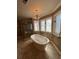 Elegant bathroom with a standalone tub, glass shower, and decorative chandelier at 3491 Roswell Ne Rd # D, Atlanta, GA 30305