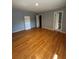 The large bedroom features hardwood floors, bright walls, and a closet and bathroom entry at 3491 Roswell Ne Rd # D, Atlanta, GA 30305