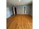 The large bedroom features hardwood floors, bright walls, and a closet and bathroom entry at 3491 Roswell Ne Rd # D, Atlanta, GA 30305