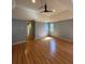 Large bedroom with hardwood floors, a ceiling fan, and large windows with light coming in at 3491 Roswell Ne Rd # D, Atlanta, GA 30305