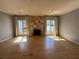 Bright living room with hardwood floors, stone fireplace, and ample natural light at 3491 Roswell Ne Rd # D, Atlanta, GA 30305