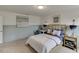 Well-lit bedroom with soft carpet and coordinated decor, including stylish artwork at 674 Allier Ter, Cumming, GA 30041