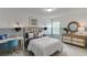 Comfortable bedroom with coordinated decor, featuring a decorative mirror and light fixtures at 674 Allier Ter, Cumming, GA 30041