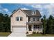 Beautiful two-story home with a brick facade, covered porch, and attached two-car garage at 674 Allier Ter, Cumming, GA 30041