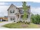 Elegant two-story brick home with a welcoming front porch and an attached two-car garage at 674 Allier Ter, Cumming, GA 30041