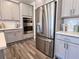 Modern kitchen with stainless steel appliances and gray cabinets at 674 Allier Ter, Cumming, GA 30041