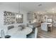 View of gray kitchen and dining area featuring modern decor and pendant lights at 674 Allier Ter, Cumming, GA 30041