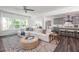 Open-concept living room featuring lots of natural light and a decorative rug. The kitchen is in the background at 674 Allier Ter, Cumming, GA 30041