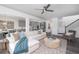 Open-concept living room leading to kitchen and dining area with hardwood floors and lots of natural light at 674 Allier Ter, Cumming, GA 30041