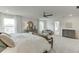 Comfortable main bedroom featuring a seating area with a bench at the foot of the bed at 674 Allier Ter, Cumming, GA 30041