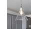 A clear glass cone shaped pendant light fixture illuminates the modern kitchen at 674 Allier Ter, Cumming, GA 30041