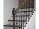 Wooden staircase with wrought iron balusters adding a touch of elegance at 674 Allier Ter, Cumming, GA 30041