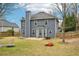 Large backyard with grass, patio, and blue siding under a bright blue sky at 1699 Boulder Walk Se Dr, Atlanta, GA 30316