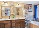 Bathroom vanity with dual sinks, bathtub, and tiled walls at 1699 Boulder Walk Se Dr, Atlanta, GA 30316