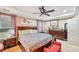 A spacious bedroom with ceiling fan, a dark wooden bedframe, and plush bedding at 1699 Boulder Walk Se Dr, Atlanta, GA 30316