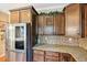 Kitchen with stainless steel refrigerator, granite countertops, and mosaic tile backsplash at 1699 Boulder Walk Se Dr, Atlanta, GA 30316