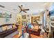 Relax in this living room with hardwood floors, fireplace, and views into kitchen and dining room at 1699 Boulder Walk Se Dr, Atlanta, GA 30316