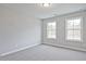 This bedroom has neutral carpet, freshly painted walls, and ample natural light from two windows at 175 Bluffington Way, Marietta, GA 30066