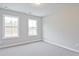 This bedroom has neutral carpet, freshly painted walls, and ample natural light from two windows at 175 Bluffington Way, Marietta, GA 30066