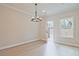 Bright dining room featuring wood-look floors, a modern chandelier, and an exterior door at 175 Bluffington Way, Marietta, GA 30066