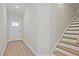 Inviting entryway with wood-look floors, a staircase, and a white front door at 175 Bluffington Way, Marietta, GA 30066