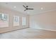 Bright, open living room featuring luxury vinyl flooring, modern fan, and natural light at 175 Bluffington Way, Marietta, GA 30066