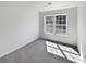 Empty bedroom showcasing a window providing natural light and neutral carpet at 20 Pine Canyon Sw Dr # 15, Atlanta, GA 30331