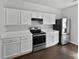 Well-lit kitchen featuring white cabinets, stainless steel appliances, and modern countertops at 20 Pine Canyon Sw Dr # 15, Atlanta, GA 30331