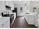 Bright kitchen featuring white cabinets, stainless steel appliances, and dark wood-look flooring at 20 Pine Canyon Sw Dr # 15, Atlanta, GA 30331