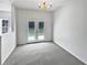 Bright, carpeted living room with a glass patio door and a chandelier at 20 Pine Canyon Sw Dr # 15, Atlanta, GA 30331