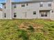The backyard with a patio extending from the light gray sided house at 1882 Byrom Pkwy, Jonesboro, GA 30236