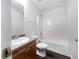 Well-lit bathroom features a shower and tub combination with a granite countertop sink at 1882 Byrom Pkwy, Jonesboro, GA 30236