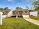 Charming two-story brick home featuring a well-manicured lawn and attached two-car garage at 1882 Byrom Pkwy, Jonesboro, GA 30236