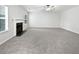 Spacious living room with plush carpeting, fireplace, and bright natural light at 1882 Byrom Pkwy, Jonesboro, GA 30236