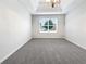 Airy main bedroom with plush carpeting, ceiling fan, and bright natural light at 1882 Byrom Pkwy, Jonesboro, GA 30236