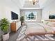 Serene main bedroom featuring a tray ceiling, soft carpet, and a neutral color palette at 1882 Byrom Pkwy, Jonesboro, GA 30236