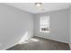 Bright bedroom with neutral paint, carpet, and natural light from window at 2025 Shawn Wayne Se Cir, Atlanta, GA 30316