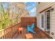 Spacious wooden deck with a bright blue chair and French doors to home at 2025 Shawn Wayne Se Cir, Atlanta, GA 30316