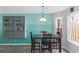Well-lit dining area features a table set for four, pendant lighting and a cabinet for storage at 2025 Shawn Wayne Se Cir, Atlanta, GA 30316