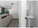 Compact and stylish powder room features a pedestal sink and a neutral color palette at 2025 Shawn Wayne Se Cir, Atlanta, GA 30316