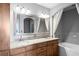 Bathroom with double vanity, granite counters, and bathtub with shower at 3445 Stratford Ne Rd # 1101, Atlanta, GA 30326