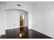 Bedroom boasts white walls, dark hardwood floors and an archway leading to a bathroom at 3445 Stratford Ne Rd # 1101, Atlanta, GA 30326
