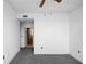 Bedroom with gray carpet, white walls, ceiling fan, and door leading to a bathroom at 3445 Stratford Ne Rd # 1101, Atlanta, GA 30326