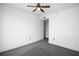 Bedroom with gray carpet, white walls, ceiling fan, and door leading to a bathroom at 3445 Stratford Ne Rd # 1101, Atlanta, GA 30326