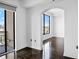 Bright bedroom showcases hardwood floors, white walls, and access to a private balcony at 3445 Stratford Ne Rd # 1101, Atlanta, GA 30326